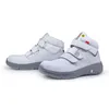A pair of white safety boots with gray soles and velcro straps, presented on a white background. Produktbild-Vorschau