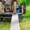 A person is loading a dirt bike onto a truck using a ramp. Náhled obrázku produktu