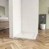 A modern bathroom corner with a white shower tray on a wooden floor, a toilet and cistern in the background. Produktbild-Vorschau