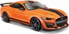 An orange Ford Mustang Shelby GT500 model car with black racing stripes. Podgląd zdjęcia produktu