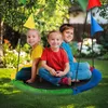 Three children are sitting on a colorful nest swing in a garden. Náhled obrázku produktu