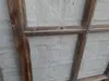 Close-up of a wooden window frame against a textured wall. Produktbild-Vorschau