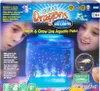 The image shows the packaging for an Aqua Dragons toy, featuring children looking at the product and illustrations of the aquatic creatures. Voir les images du produit