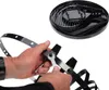 Hands assembling a black metal fire basket with an ash catcher. Produktbild-Vorschau