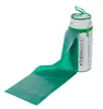 A green Theraband exercise band is partially unrolled from its cylindrical storage case. Produktbild-Vorschau
