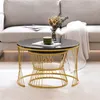 A set of nesting coffee tables with marble-look tops and gold metal frames are placed in a living room setting next to a sofa. Náhľad obrázku produktu