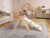 A children's indoor play area with a wooden climbing triangle and slide, a sofa, a desk, and storage shelves. Anteprima dell’immagine prodotto
