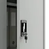A close-up view of a metal cabinet lock and key, with binders visible inside the cabinet. Náhľad obrázku produktu