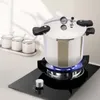 A pressure cooker is shown on a stovetop. Podgląd zdjęcia produktu