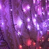 A close-up view of string lights draped over a tapestry with a mandala pattern. Náhled obrázku produktu