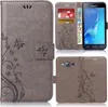 A collage of images showing a grey flip phone case with a floral pattern, a Samsung phone inserted into the case, and close-ups of the case's features. Produktbild-Vorschau