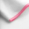 A close-up view of the edge of a white fabric with a pink trim. Anteprima dell’immagine prodotto