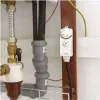 Close-up view of plumbing fixtures and an electrical thermostat. Podgląd zdjęcia produktu