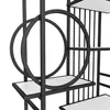 A close-up view of a black metal bookshelf with white shelves and decorative circular elements. Podgląd zdjęcia produktu
