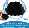 A hand holding a black filter ball with a pile of filter balls in the background, surrounded by water splashes. Náhľad obrázku produktu