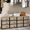 A closet scene with clothing hanging and a storage unit with drawers. Podgląd zdjęcia produktu