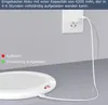 A white charging base with a white cable plugged into a wall socket. Produktbild-Vorschau