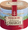 A cylindrical container of Fleur de Sel salt, featuring a scenic illustration of a coastal town and a salt harvester. Produktbild-Vorschau