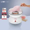 A Clatronic cotton candy maker in use, with cotton candy being spun and placed on a stick. There are awards and text overlays on the left side of the image. Podgląd zdjęcia produktu