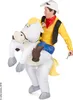 A man wearing a cowboy costume is riding an inflatable horse. Produktbild-Vorschau