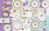 An Easter-themed table setting with plates, cups, and decorative eggs. Produktbild-Vorschau