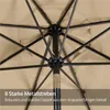 Close-up view of the internal structure of a beige umbrella, showing the metal ribs and fabric. Produktbild-Vorschau