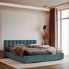 A bedroom scene with a teal upholstered bed as the main focus, styled with bedding and throws. A large window with brown curtains is visible in the background. Anteprima dell’immagine prodotto