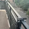 A balcony with a drying rack attached to the railing, overlooking a street. Produktbild-Vorschau