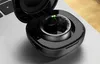 A smart ring is shown inside its charging case, which is placed on a laptop. Voir les images du produit