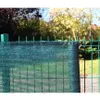 A green privacy screen is attached to a wire fence in an outdoor setting. Podgląd zdjęcia produktu