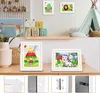 A children's room with framed artwork displayed on a shelf and a table. Náhľad obrázku produktu