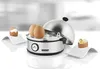 A stainless steel egg cooker with three eggs, two inside the cooker and one on a white egg cup to the left, and a partially eaten egg on a white egg cup to the right. Produktbild-Vorschau
