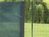 A close-up view of a green privacy screen attached to a wire fence. Náhled obrázku produktu