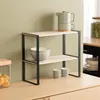 A two-tiered shelf unit with kitchenware on a countertop. Anteprima dell’immagine prodotto