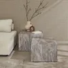 Two square marble-look side tables are placed next to a beige sofa in a room with a textured wall. Produktbild-Vorschau