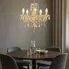 A dining table set with a chandelier above. Anteprima dell’immagine prodotto
