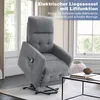 A gray recliner chair with a lift function is shown in a well-lit room with large windows. Náhľad obrázku produktu