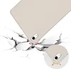 A tablet case is shown being dropped onto a cracked surface, illustrating its protective qualities. Produktbild-Vorschau