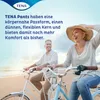 A couple riding bicycles on a beach. Produktbild-Vorschau