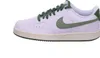 A side view of a white Nike Court Vision Low sneaker with green accents. Produktbild-Vorschau