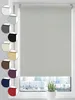 A roller blind in a light gray color is shown, with various color swatches of the same product displayed on the left side. The blind is installed on a window overlooking a city skyline. A potted plant is visible on the windowsill. Produktbild-Vorschau