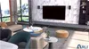 A modern living room with a sofa, coffee table, and entertainment center. Produktbild-Vorschau