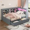 A child's bedroom with a grey daybed, shelves, and storage drawers. The bed is made with pink and white bedding, and there are decorative clouds and stars on the wall. Produktbild-Vorschau