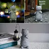 A collage of three images showing a decorative cat figurine holding a solar lantern, displayed in different settings. Produktbild-Vorschau