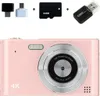 A pink digital camera with accessories including a memory card and USB adapter, presented against a white background. Produktbild-Vorschau