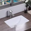 A white rectangular sink with a chrome faucet is shown on a wooden countertop, with a city view visible through a window in the background. Náhľad obrázku produktu