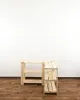 Two wooden shelf units are placed side-by-side on a wooden floor against a white wall. Produktbild-Vorschau