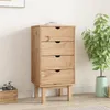 A wooden chest of drawers with four drawers, standing on four legs, in a room with a plant and a basket with a camera. Náhled obrázku produktu