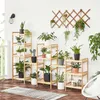 A collection of wooden plant stands with various potted plants on a patio or balcony. Produktbild-Vorschau