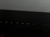 A close-up view of the control buttons on a black electronic device, possibly a television or monitor, with labels like 'M', 'V-', 'V+', 'CH-', and 'CH+'. Produktbild-Vorschau